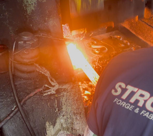 Man using forging machine